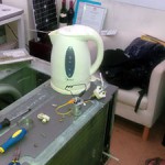 Water heater used to discharge the start capacitor in order to avoid electrocution
